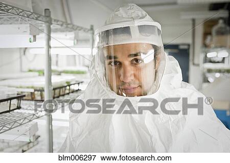 Stock Photo - Middle Eastern scientist in clean suit in laboratory. Fotosearch