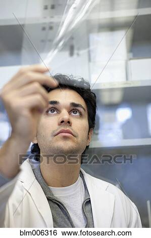 Stock Photograph - Middle Eastern scientist working in laboratory. Fotosearch