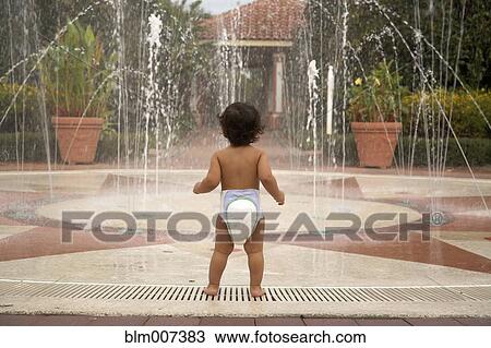 Mixed race baby wearing diaper standing near fountain View Large Photo Image Stock Image - Mixed race baby wearing diaper standing near fountain. Fotosearch