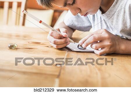 Mixed race boy coloring at desk View Large Photo Image Stock Photo - Mixed race boy coloring at desk. Fotosearch