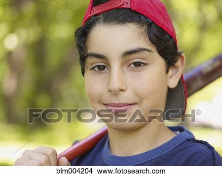 Picture - Mixed race boy holding baseball bat. Fotosearch