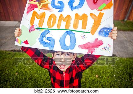 Stock Photography - Mixed race boy holding Go mommy go sign. Fotosearch