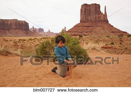Mixed race boy playing in dirt in Monument Valley View Large Photo Image Stock Photo - Mixed race boy playing in dirt in Monument Valley. Fotosearch