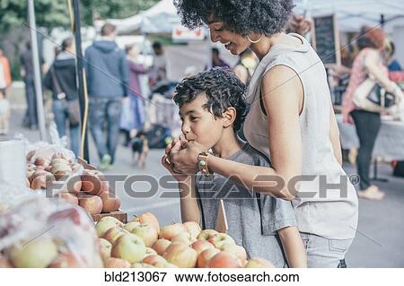 Mixed race boy shopping with mother at farmers market View Large Photo Image Stock Photo - Mixed race boy shopping with mother at farmers market. Fotosearch