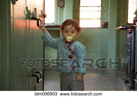 Mixed race boy standing in kitchen View Large Photo Image Stock Image - Mixed race boy standing in kitchen. Fotosearch