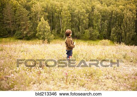 Mixed race boy standing in rural field View Large Photo Image Stock Photograph - Mixed race boy standing in rural field. Fotosearch