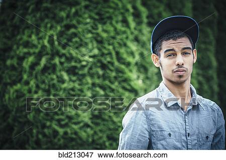 Stock Photo - Mixed race boy standing outdoors. Fotosearch
