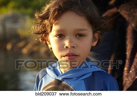Stock Photo - Mixed race boy with serious expression. Fotosearch