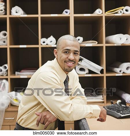 Mixed race businessman in filing room View Large Photo Image Stock Image - Mixed race businessman in filing room. Fotosearch
