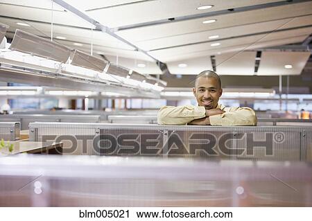 Mixed race businessman leaning on cubicle wall View Large Photo Image Stock Image - Mixed race businessman leaning on cubicle wall. Fotosearch
