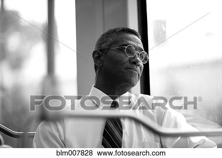 Stock Photo - Mixed race businessman rising commuter train. Fotosearch