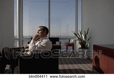Mixed race businessman sitting in armchair and looking pensive View Large Photo Image Stock Image - Mixed race businessman sitting in armchair and looking pensive. Fotosearch