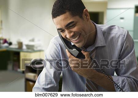 Stock Photo - Mixed race businessman talking on telephone. Fotosearch