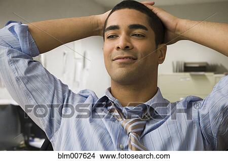 Picture - Mixed race businessman with hands on head. Fotosearch