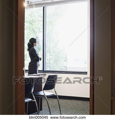 Mixed race businesswoman looking out window View Large Photo Image Stock Photography - Mixed race businesswoman looking out window. Fotosearch