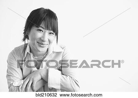 Stock Image - Mixed race businesswoman smiling. Fotosearch