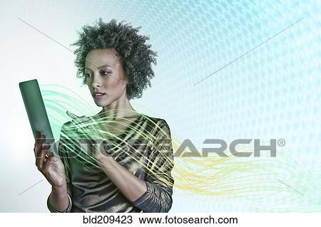 Stock Image - Mixed race businesswoman using digital tablet. Fotosearch