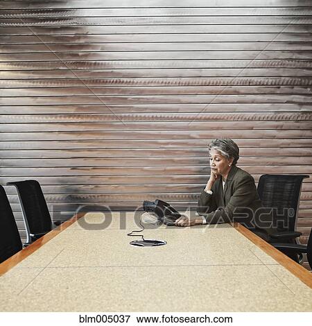 Stock Photo - Mixed race businesswoman waiting for conference call. Fotosearch