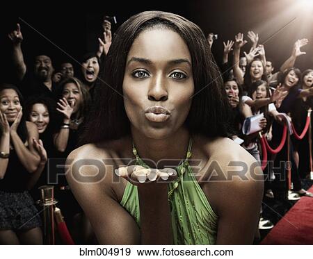 Mixed race celebrity blowing kisses at red carpet event View Large Photo Image Stock Photo - Mixed race celebrity blowing kisses at red carpet event. Fotosearch