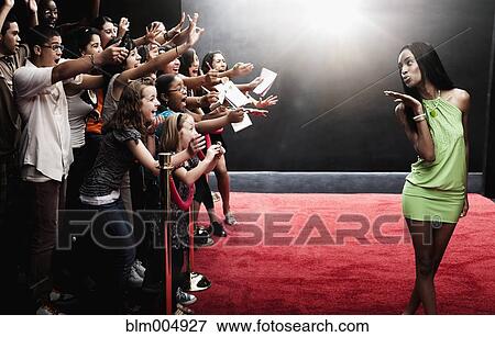 Mixed race celebrity blowing kisses at red carpet event View Large Photo Image Stock Photo - Mixed race celebrity blowing kisses at red carpet event. Fotosearch