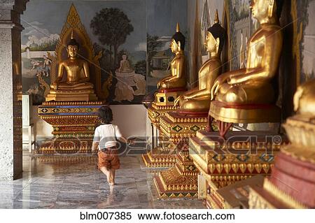 Mixed race child running past Buddha statues View Large Photo Image Stock Photography - Mixed race child running past Buddha statues. Fotosearch