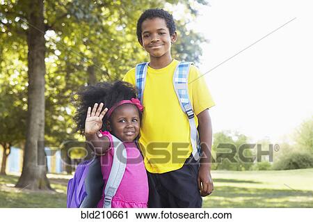 Stock Image - Mixed race children smiling together. Fotosearch
