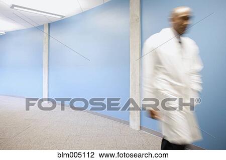 Mixed race doctor rushing in hospital hallway View Large Photo Image Stock Image - Mixed race doctor rushing in hospital hallway. Fotosearch