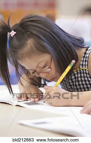 Mixed race Down syndrome student writing in workbook View Large Photo Image Stock Image - Mixed race Down syndrome student writing in workbook. Fotosearch