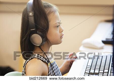 Mixed race Down syndrome student using computer View Large Photo Image Stock Photo - Mixed race Down syndrome student using computer. Fotosearch