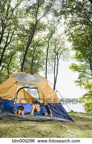 Stock Photograph - Mixed race father and son camping. Fotosearch
