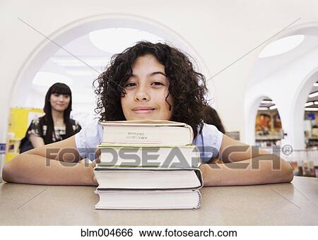 Mixed race girl checking out books from library View Large Photo Image Stock Photograph - Mixed race girl checking out books from library. Fotosearch