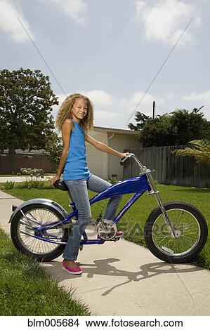 Picture - Mixed race girl on bicycle. Fotosearch