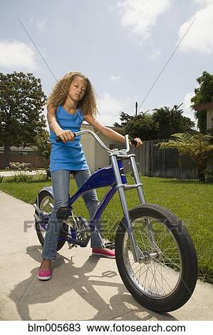 Mixed race girl on bicycle View Large Photo Image Stock Image - Mixed race girl on bicycle. Fotosearch