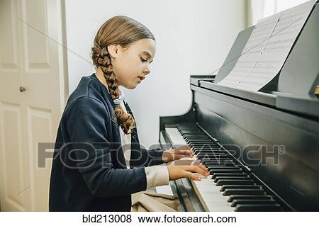Mixed race girl playing piano View Large Photo Image Stock Photo - Mixed race girl playing piano. Fotosearch