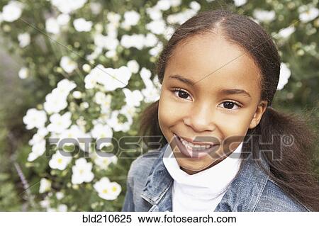 Mixed race girl smiling outdoors View Large Photo Image Stock Photography - Mixed race girl smiling outdoors. Fotosearch