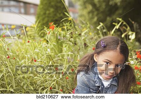 Stock Photo - Mixed race girl wearing flowers in her hair. Fotosearch