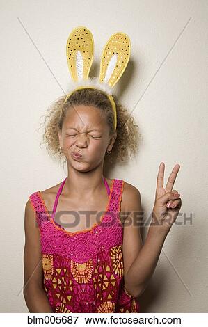 Stock Photo - Mixed race girl with bunny ears. Fotosearch