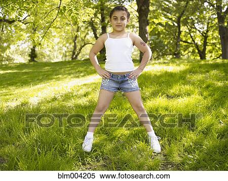 Mixed race girl with hands on hips in grass View Large Photo Image Stock Photography - Mixed race girl with hands on hips in grass. Fotosearch