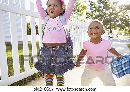 Stock Photo - Mixed race girls playing on suburban street. Fotosearch