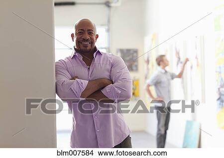 Picture - Mixed race man in art gallery. Fotosearch