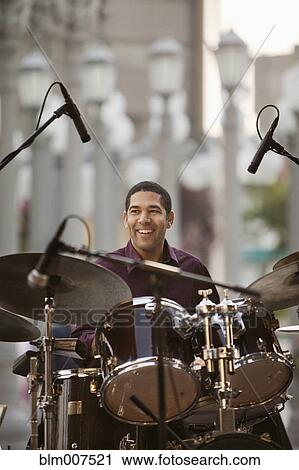 Mixed race man playing drums View Large Photo Image Stock Image - Mixed race man playing drums. Fotosearch