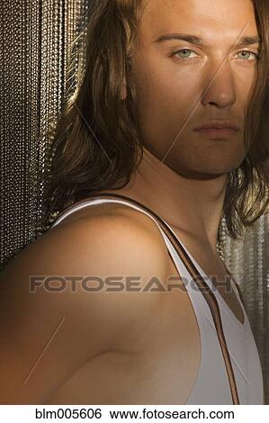 Mixed race man standing by chain curtain View Large Photo Image Stock Photograph - Mixed race man standing by chain curtain. Fotosearch