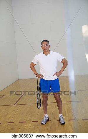Mixed race man standing in racquetball court View Large Photo Image Stock Photo - Mixed race man standing in racquetball court. Fotosearch