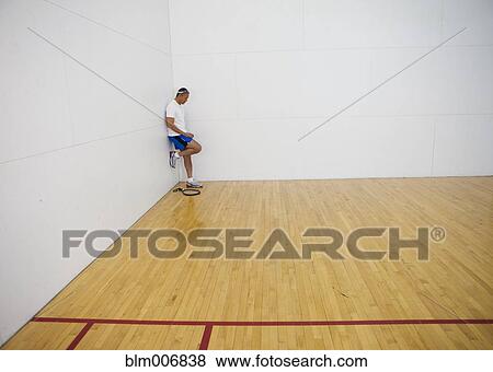 Mixed race man standing in racquetball court View Large Photo Image Stock Photo - Mixed race man standing in racquetball court. Fotosearch