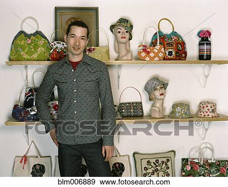 Mixed race man standing in retro purse shop View Large Photo Image Stock Photo - Mixed race man standing in retro purse shop. Fotosearch
