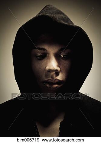 Mixed race man wearing hooded sweatshirt View Large Photo Image Stock Photo - Mixed race man wearing hooded sweatshirt. Fotosearch