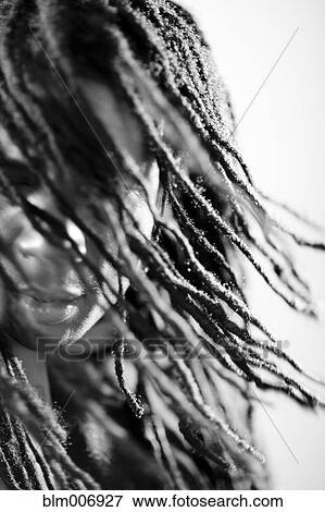 Stock Photo - Mixed race man with long dreadlocks. Fotosearch