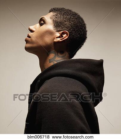 Mixed race man with tattoo wearing hooded sweatshirt View Large Photo Image Stock Photo - Mixed race man with tattoo wearing hooded sweatshirt. Fotosearch