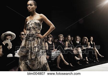 Stock Photo - Mixed race model on runway in fashion show. Fotosearch