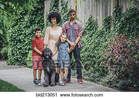 Mixed race mother and children smiling with dog on suburban sidewalk View Large Photo Image Stock Image - Mixed race mother and children smiling with dog on suburban sidewalk. Fotosearch